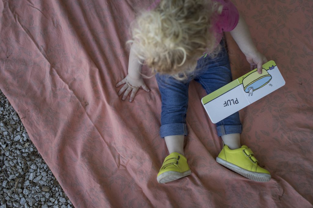 Una bimba piccola con in mano un libro illustrato